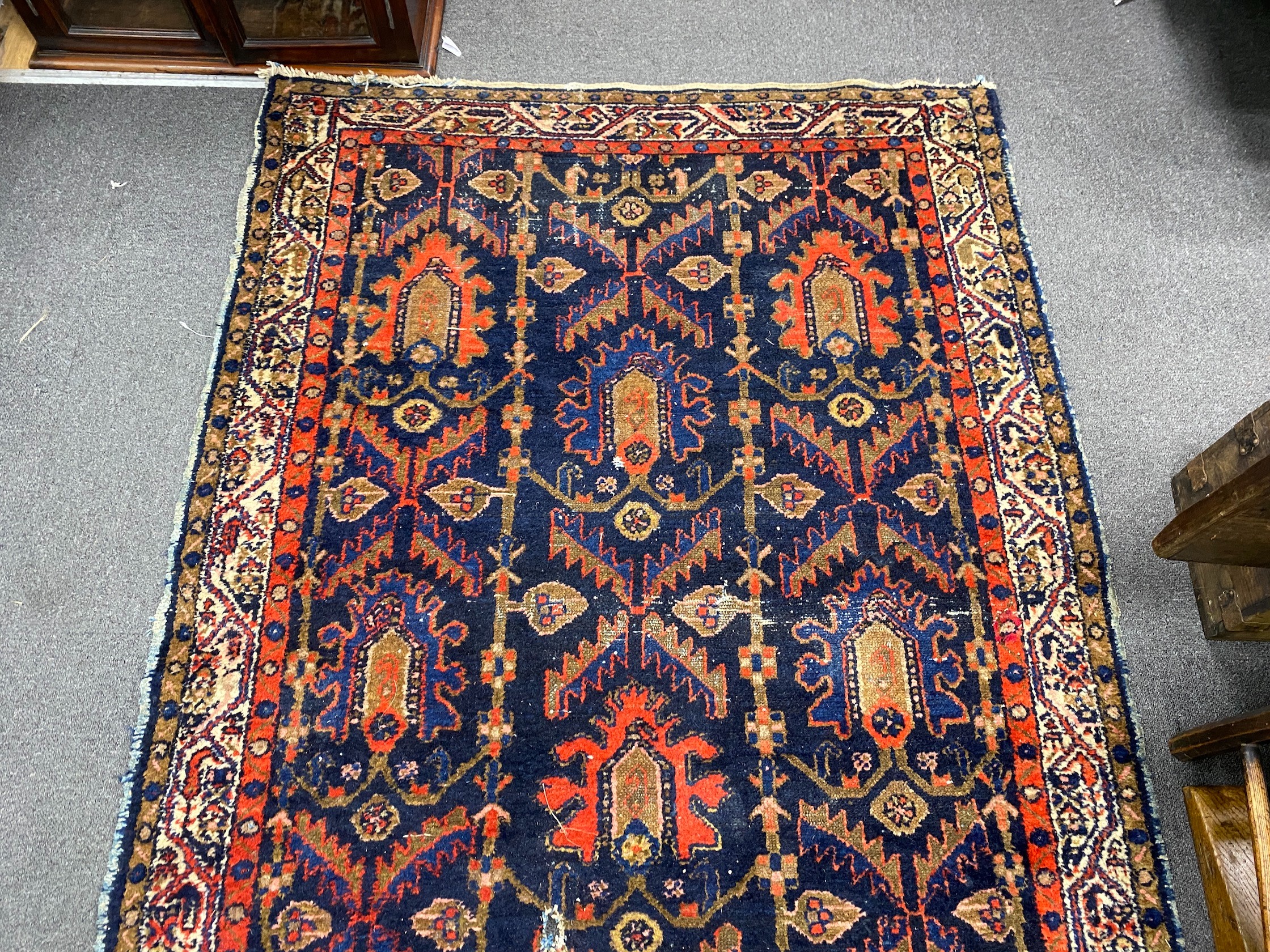 An antique Caucasian blue ground rug, 194 x 132cm